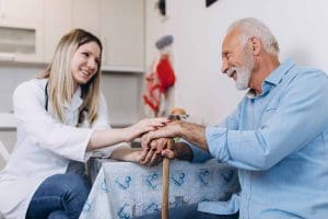 Live in home caregiver assisting senior with daily care